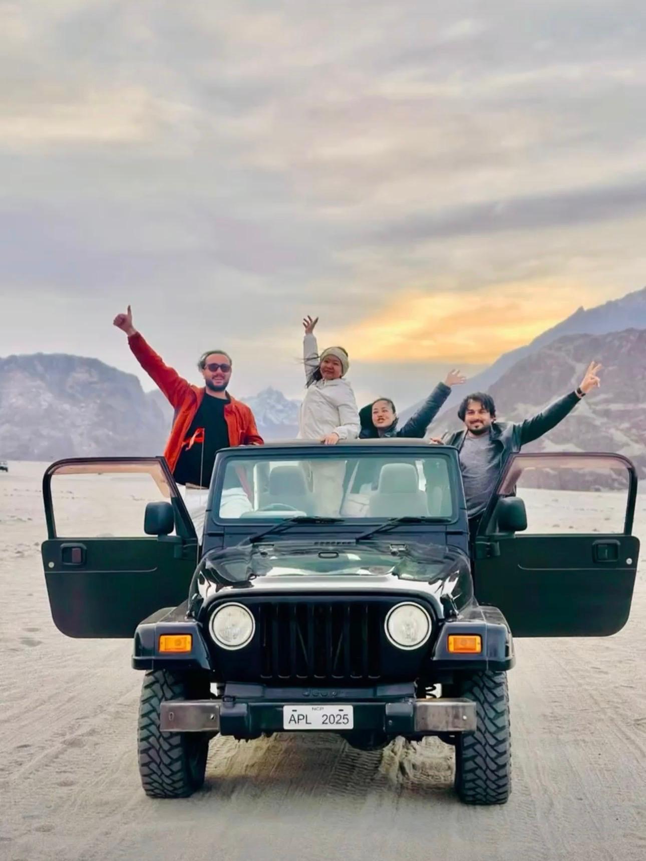 Small group of travelers in a Land Cruiser on a Karakoram road